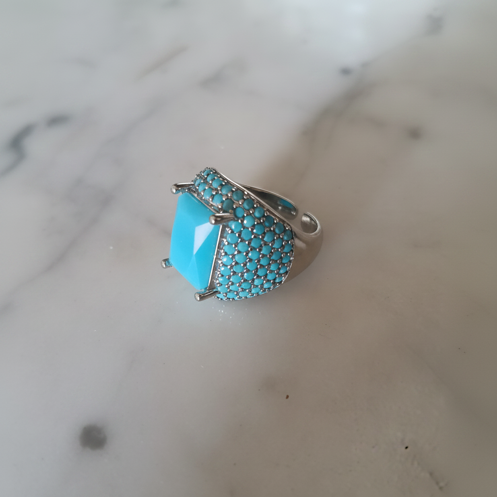 Anillo Yasmine turquesa con circonitas sobre mármol, vista cenital